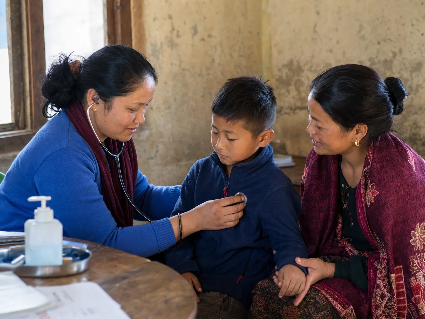 Illustration of a community health worker supporting a child